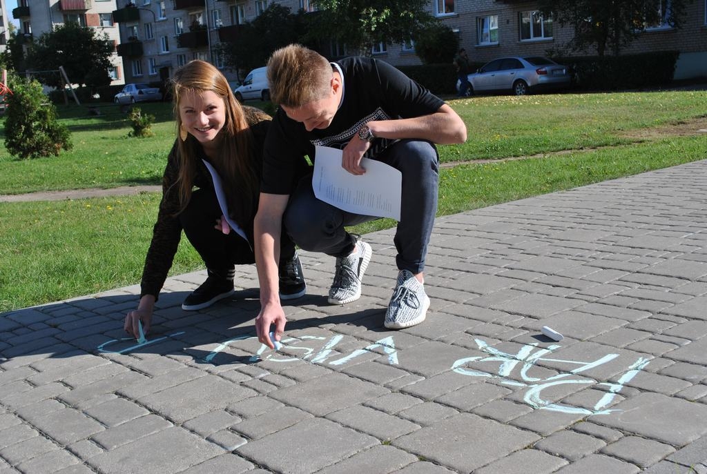 Aizkraukles skolēni uz trotuāra raksta dzeju  